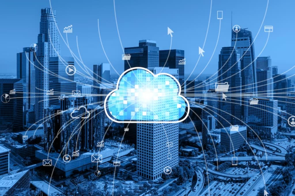 A blue-toned cityscape with a glowing cloud symbol and data connections