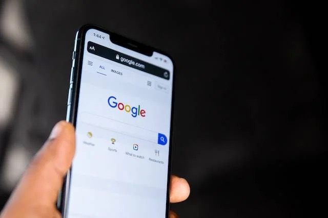 Hand holding phone with open browser