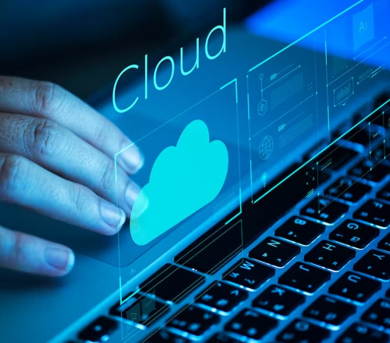 A hand pressing a virtual cloud icon over a keyboard for cloud access